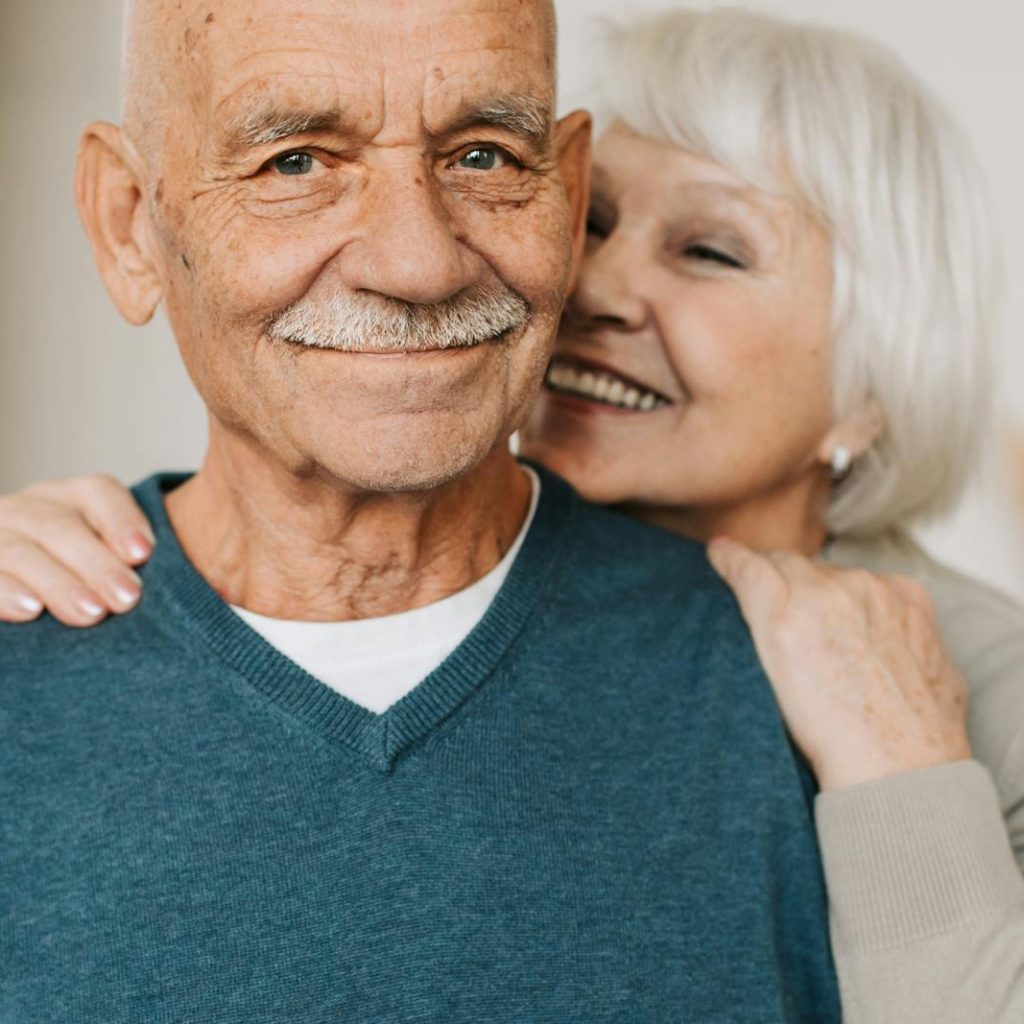 Joyful senior couple in an affectionate embrace, capturing love.